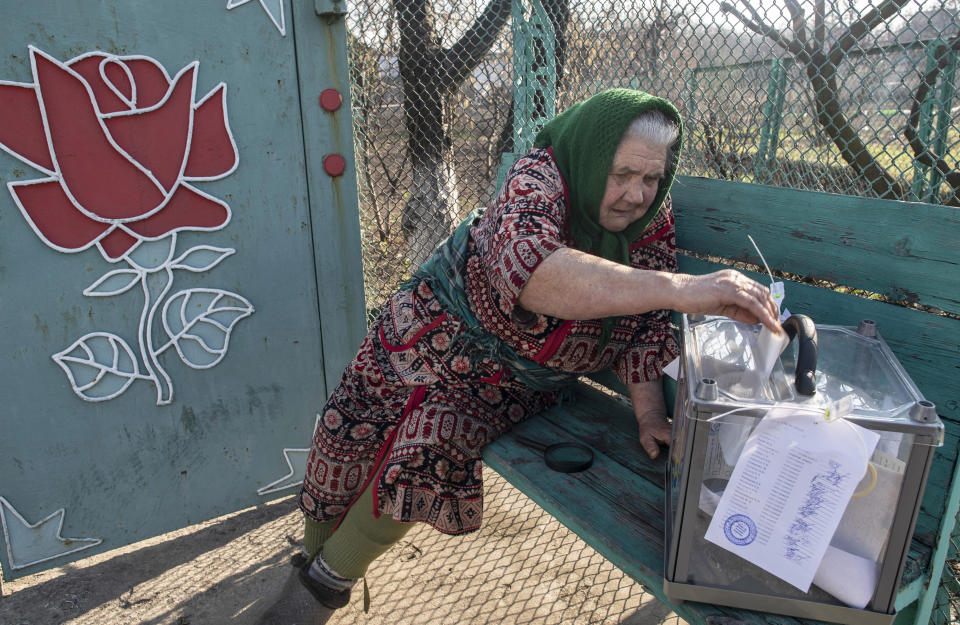 An elderly woman casts her ballot at home during the presidential election in Mariinka, near a contact line not far from Donetsk, eastern Ukraine, Sunday, March 31, 2019. Ukrainians choose from among 39 candidates for a president they hope can guide the country of more than 42 million out of troubles including endemic corruption, a seemingly intractable conflict with Russia-backed separatists in the country's east and a struggling economy. (AP Photo/Evgeniy Maloletka)