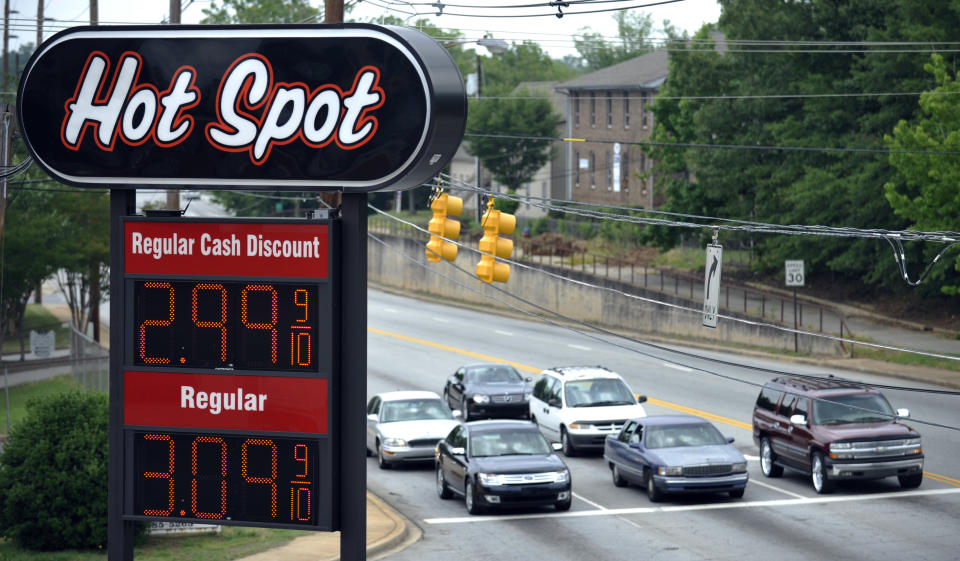 A sign for $2.99 a gallon gasoline is seen as vehicles wait for a traffic light to turn green at a Hot Spot convenience store on the corner of Henry and Converse Streets on Friday, June 1, 2012 in Spartanburg, S.C. Oil prices plunged as bleak reports on U.S. job growth and manufacturing heightened worries about a slowing global economy. (AP Photo/Rainier Ehrhardt)