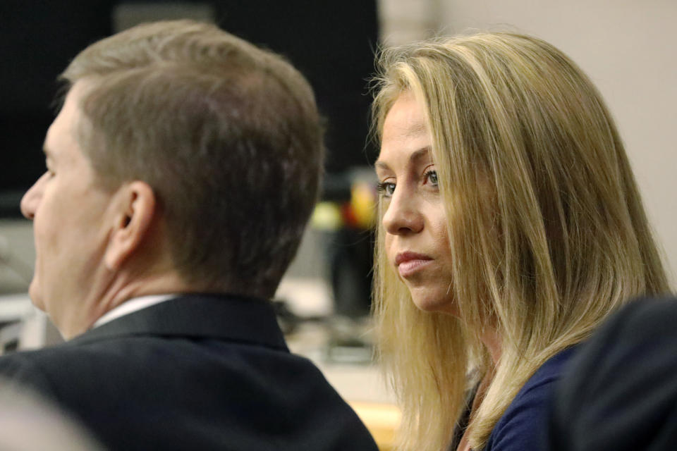 FILE - In this Sept. 25, 2019, file photo, fired Dallas police officer Amber Guyger looks toward her attorney before proceedings in her murder trial in Dallas. A Texas appeals court has upheld the murder conviction of Guyger, who was sentenced to prison for fatally shooting her neighbor in his home. A panel of three state judges on Thursday, Aug. 5, 2021, ruled that a Dallas County jury had sufficient evidence to convict Guyger of murder in the 2018 shooting of Botham Jean. (Tom Fox/The Dallas Morning News via AP, Pool, File)