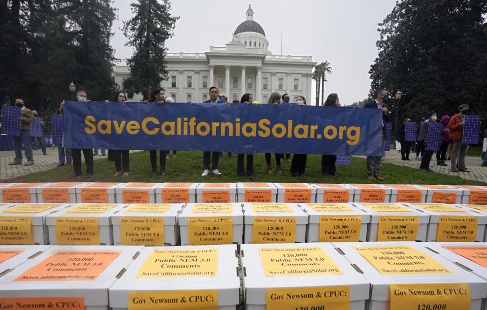 Boxes of petitions against proposed reforms that solar energy advocates claim would handicap the rooftop solar market are displayed before they are taken to the governor's office during a rally at the Capitol in Sacramento, Calif., Wednesday, Dec. 8, 2021. State regulators at the California Public Utilities Commission are expected to propose reforms that would lower the financial incentives for homeowners who install solar panels. (AP Photo/Rich Pedroncelli)
