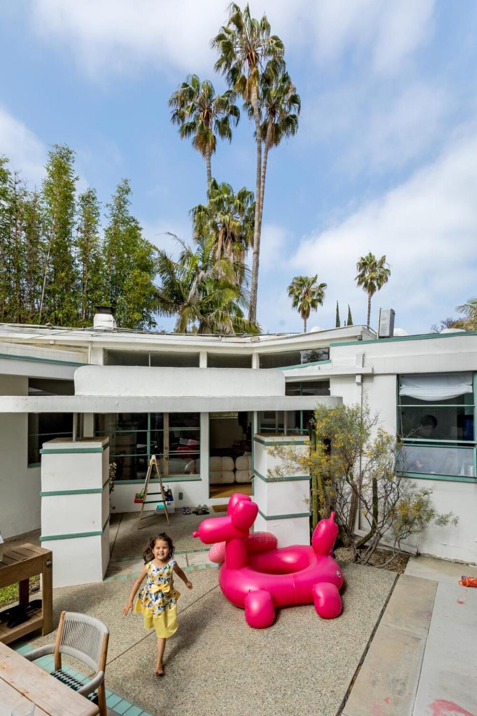 A young girl runs outside the Kesling house.