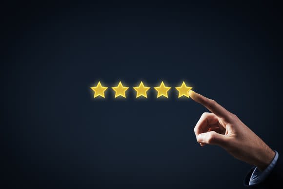 A person touching the fifth star in a row of five stars