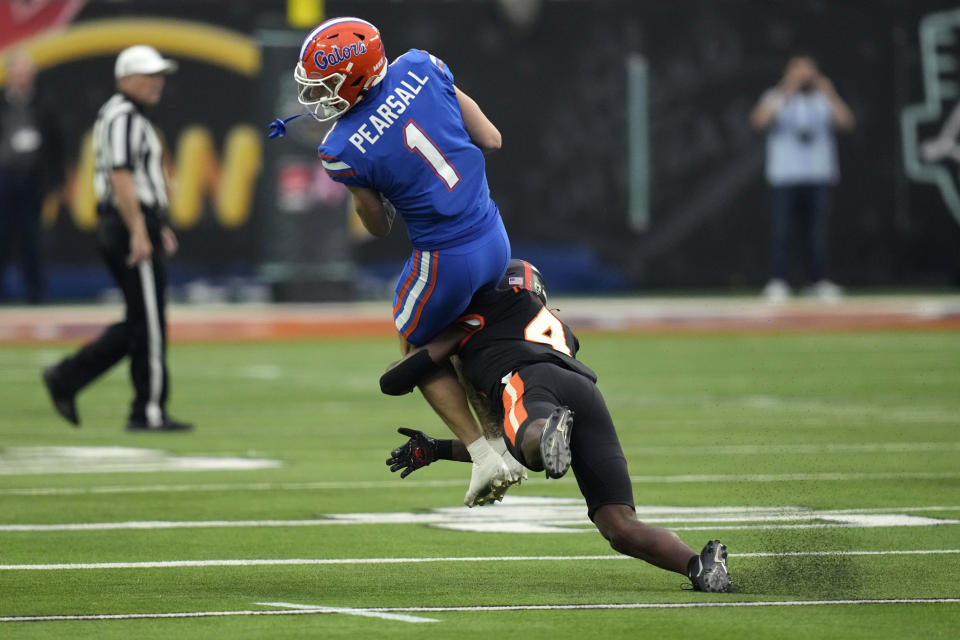 Florida wide receiver Ricky Pearsall (1) catches a pass over Oregon State defensive back Jaden Robinson (4) during the first half of the Las Vegas Bowl NCAA college football game Saturday, Dec. 17, 2022, in Las Vegas. (AP Photo/John Locher)