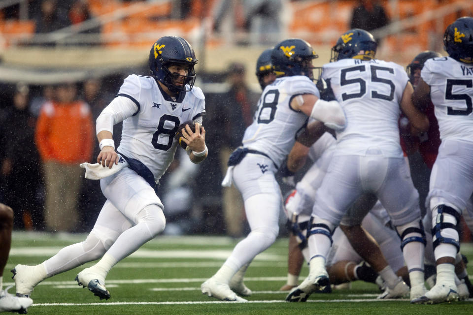 West Virginia quarterback Nicco Marchiol (8) runs with the ball during the second half of the NCAA college football game against Oklahoma State in Stillwater, Okla., Saturday Nov. 26, 2022. (AP Photo/Mitch Alcala)