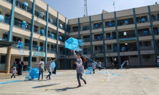 Palestinian girls fly kites in the courtyard of an UNRWA-run school in Gaza during a protest against US aid cuts that threatened their education until other donors stepped in