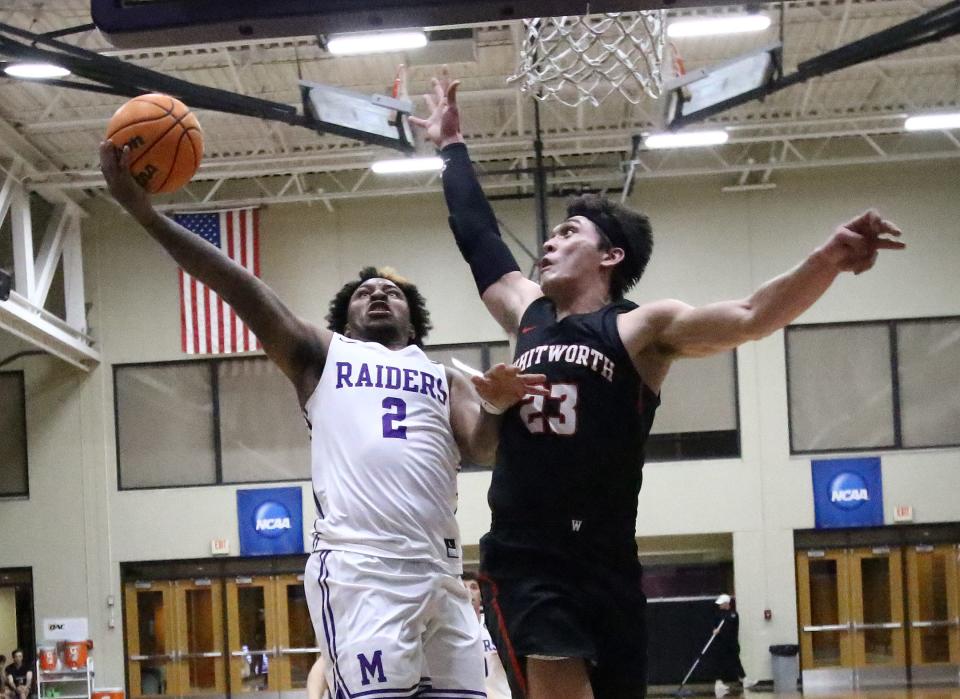 Mount Union's Collen Gurley, left, is defended by Whitworth's Jake Holtz during the season opener Friday, November 11, 2022.