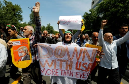 Iranians hold placards bearing anti-US slogans during a demonstration after Friday prayers in the capital Tehran on May 11, 2018