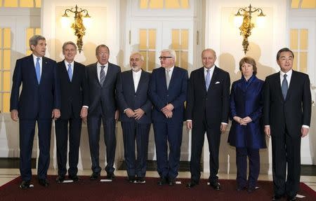 U.S. Secretary of State John Kerry, Britain's Foreign Secretary Philip Hammond, Russian Foreign Minister Sergei Lavrov, Iranian Foreign Minister Javad Zarif, German Foreign Minister Frank-Walter Steinmeier, French Foreign Minister Laurent Fabius, EU High Representative Catherine Ashton, Chinese Foreign Minister Wang Yi (L-R) pose for a family picture during their meeting in Vienna November 24, 2014. REUTERS/Joe Klamar/Pool