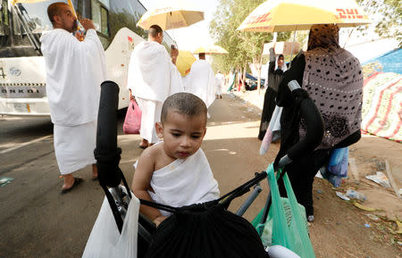 Mazen, 1, a Muslim pilgrim gather with his parents on Mount Mercy on the plains of Arafat during the annual haj pilgrimage, outside the holy city of Mecca, Saudi Arabia August 20, 2018. REUTERS/Zohra Bensemra