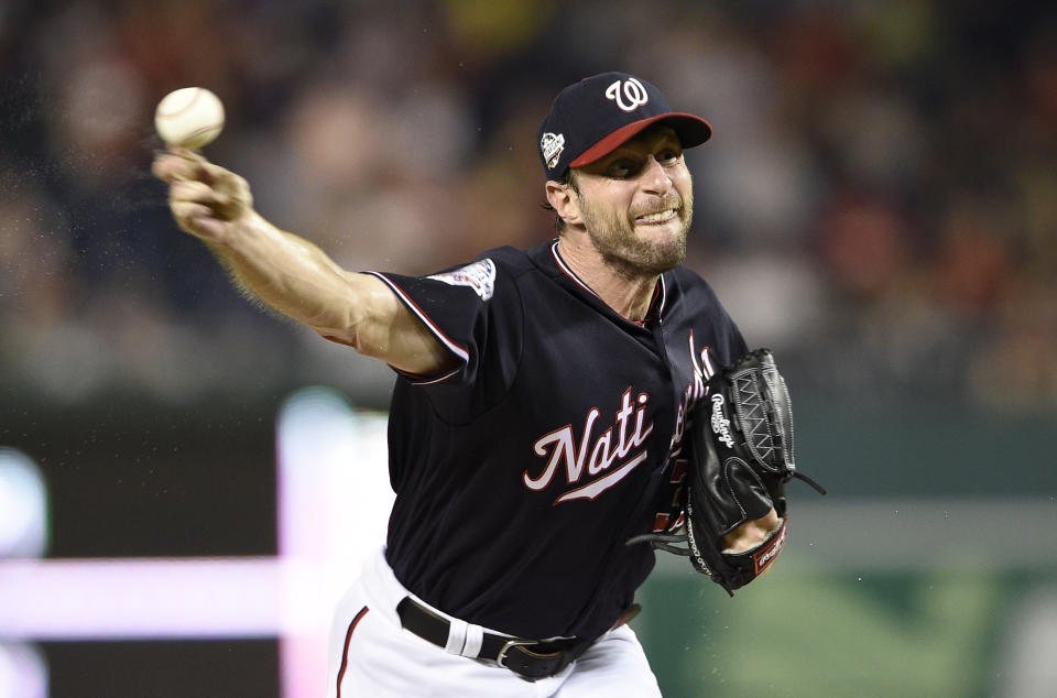 FILE - In this Sept. 25, 2018, file photo, Washington Nationals starting pitcher Max Scherzer delivers during the fourth inning of a baseball game against the Miami Marlins in Washington. If three-time Cy Young Award winner Scherzer has his way, Major League Baseball's pitch clock will die in the South Florida humidity. (AP Photo/Nick Wass, File)