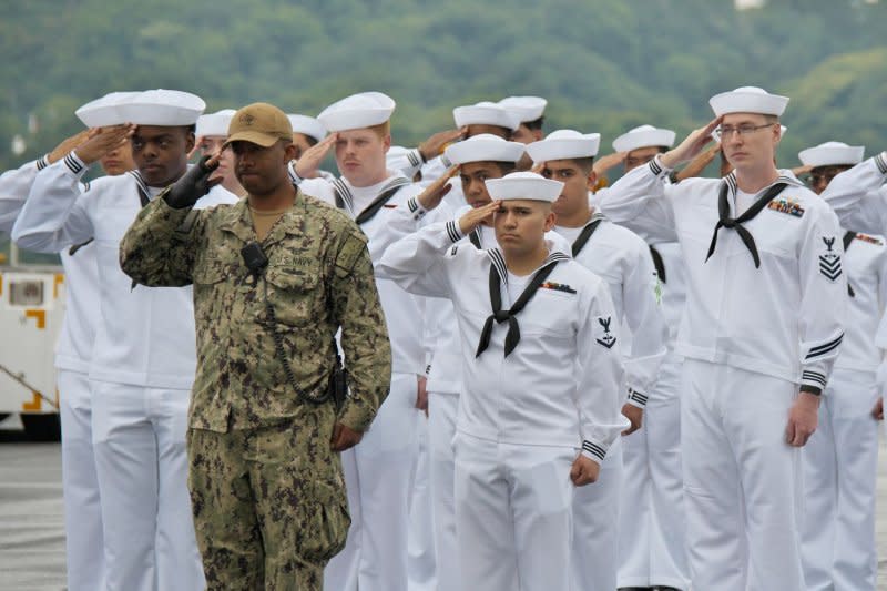 Sailors of the U.S. Navy aircraft carrier USS Ronald Reagan salute at Fleet Activities Yokosuka in Kanagawa-Prefecture, Japan on Thursday. Photo by Keizo Mori/UPI