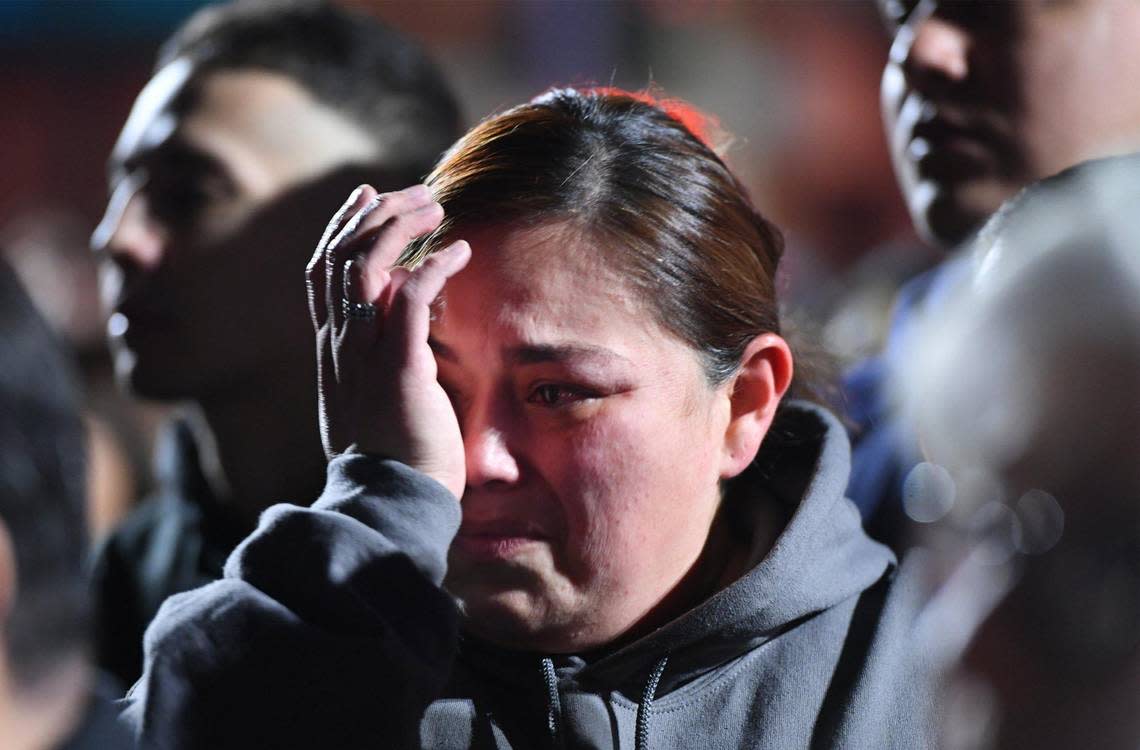A woman wipes tears from her eye as the community gathers at a vigil in Veterans Park for slain Selma officer Gonzalo Carrasco Jr. Thursday, Feb 2, 2023 in Selma.