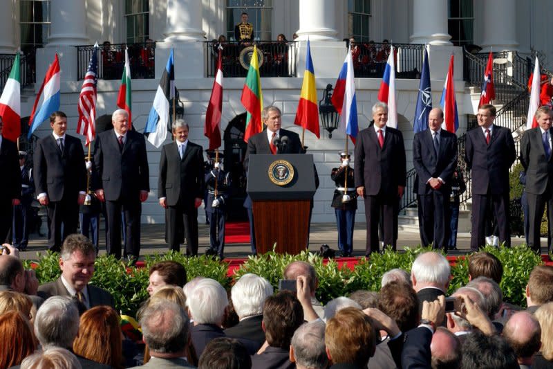 President George Bush (C) welcomes seven new members to NATO during a ceremony on the South Lawn of the White House on March 29, 2004. The prime ministers with Bush are, from left to right, Indulis Emsis of Latvia, Anton Rop of Slovenia, Algirdas Brazauskas of Lithuania, Mikulas Dzurinda of Slovakia, Adrian Nastase of Romania, Simeon Saxe-Coburg Gotha of Bulgaria, Juhan Parts of Estonia, and NATO Secretary-General Jaap de Hoop Scheffer. File Photo by Roger L. Wollenberg/UPI