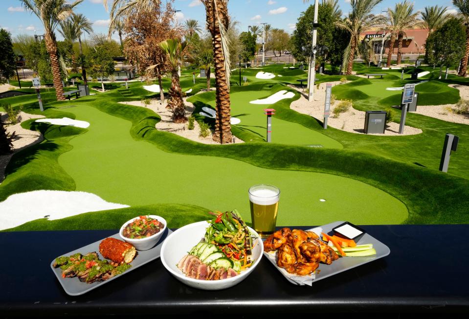 Feb 28, 2023; Glendale, AZ, USA; Churrasco Skirt Steak, Seared Ahi Tuna, and Grilled Wings (right) at Popstroke Glendale which features two 18-hole putting courses. Popstroke is created by Tiger Woods and his TGR Design team featuring a full-service open-air restaurant, an outdoor game area, a playground, and an ice cream parlor at Westgate Entertainment District. Mandatory Credit: Rob Schumacher-Arizona Republic