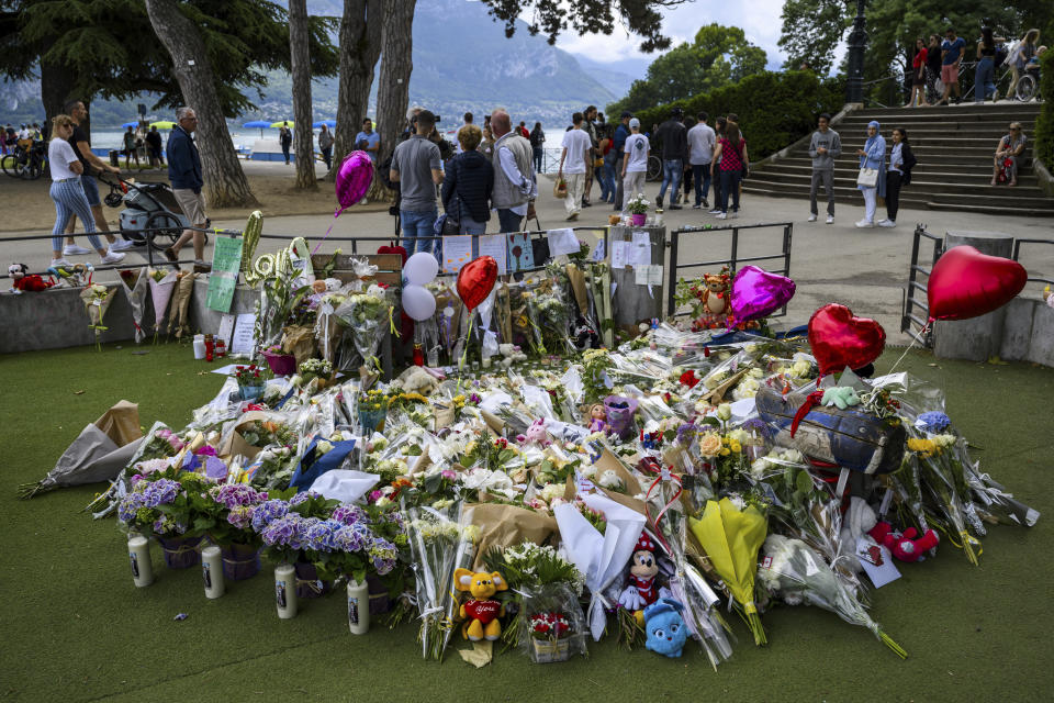 Flowers are laid down at a children's playground in Annecy, France, Saturday, June 10, 2023 following a knife attack on Thursday, June 8, 2023. French judges have handed preliminary charges of attempted murder to a man suspected of stabbing four young children and two adults in a French Alps park. The suspect is a 31-year-old Syrian refugee with permanent residency in Sweden. (Jean-Christophe Bott/Keystone via AP)