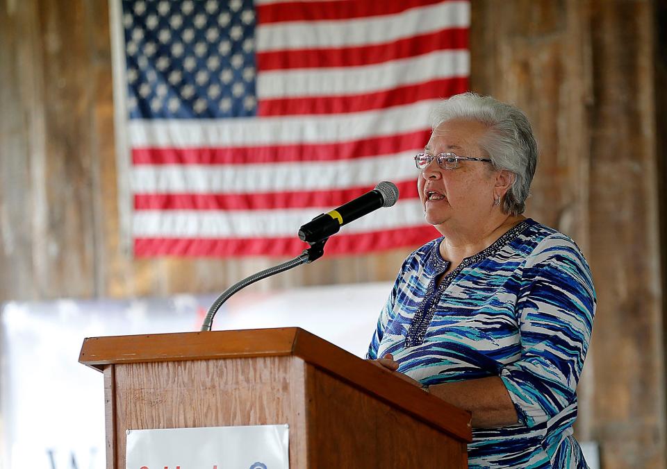 Old Uniontown Quilt Guild's Marcia Puster explains the raffle of 38 quilts made by the guild and other crafters. Three afghans also were given away to area veterans in a drawing.