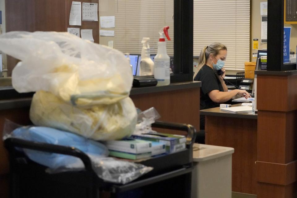 A registered nurse talks on a phone inside the emergency room at Scotland County Hospital in Memphis, Missouri.