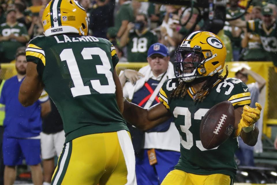 Green Bay Packers' Aaron Jones celebrates his touchdown run with Allen Lazard during the second half of an NFL football game against the Detroit Lions Monday, Sept. 20, 2021, in Green Bay, Wis. (AP Photo/Matt Ludtke)