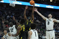 Oregon guard Jermaine Couisnard (5) grabs a rebound against Colorado during the first half of an NCAA college basketball game in the championship of the Pac-12 tournament Saturday, March 16, 2024, in Las Vegas. (AP Photo/John Locher)