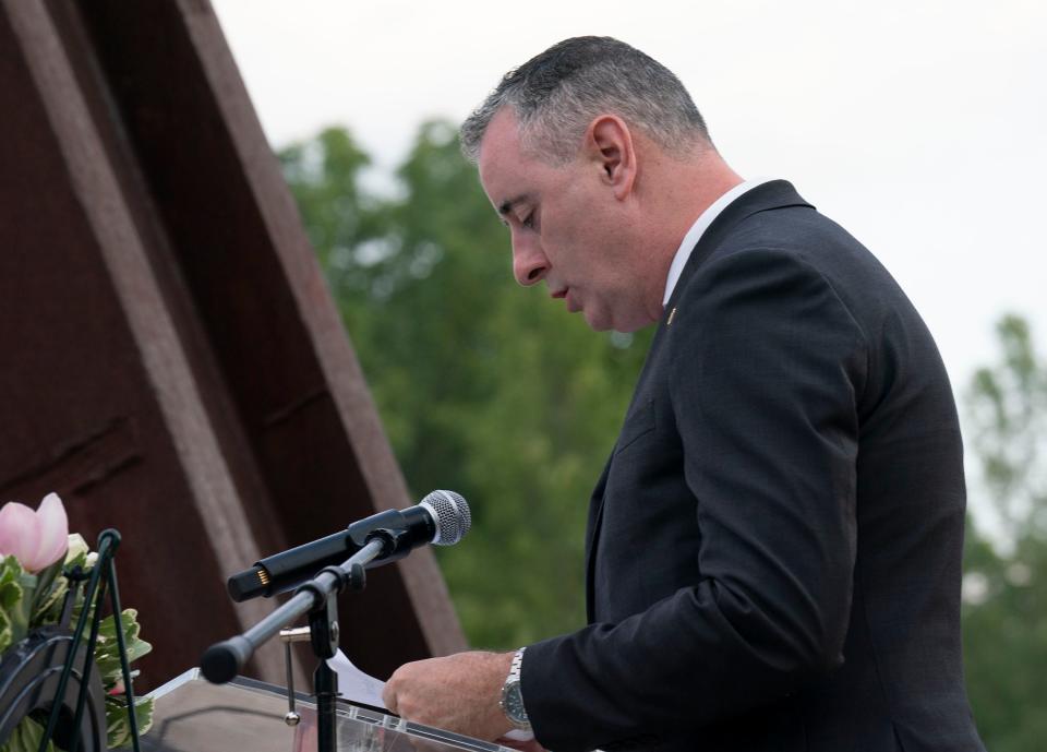 Congressman Brian Fitzpatrick reading the names at the vigil honoring both victims and survivors of the recent flash flooding in Upper Makefield at the 911 Memorial Garden of Reflection in Yardley on Sunday, July 23, 2023.