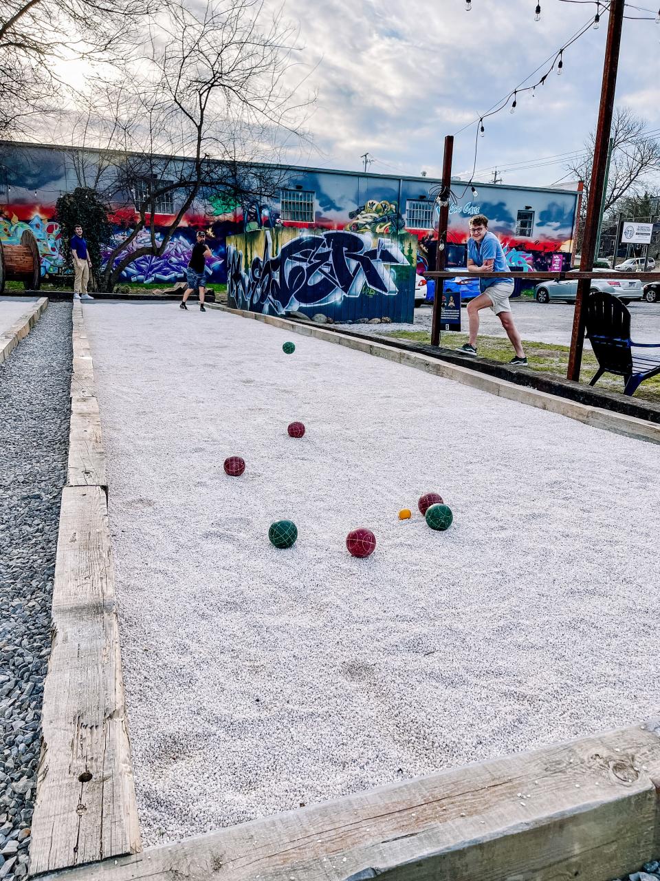 Jeff Siglow demonstrates a Volo shot, an aerial shot where the player attempts to hit other bocce balls or the pallino before it touches the ground, at Southside Garage.