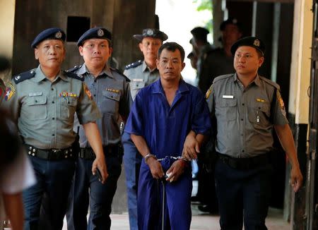 Detained Police Captain Moe Yan Naing (C) escorted by police arrives for a court hearing in Yangon, Myanmar May 9, 2018. REUTERS/Stringer