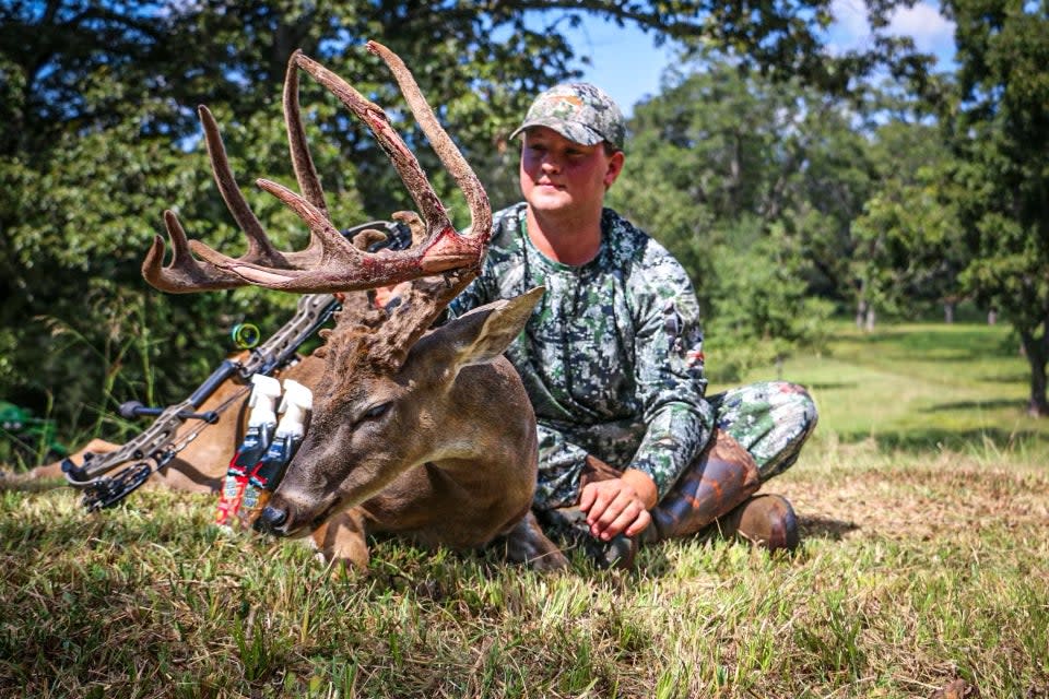 photo of the hunter posing with his big velvet buck