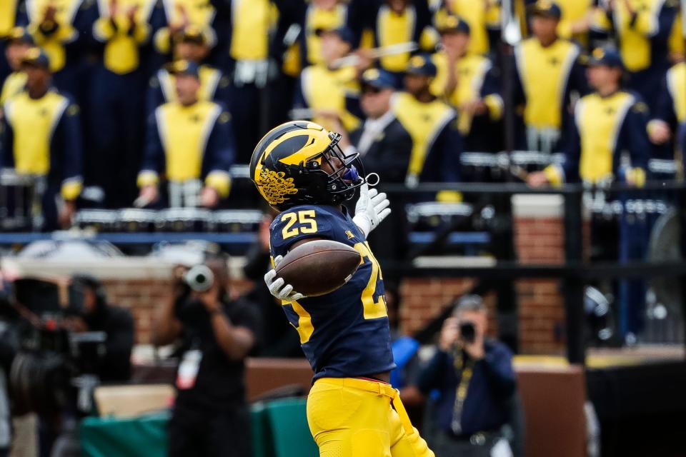 Michigan running back Hassan Haskins (25) celebrates a touchdown against Rutgers during the first half at Michigan Stadium in Ann Arbor on Saturday, Sept. 25, 2021.