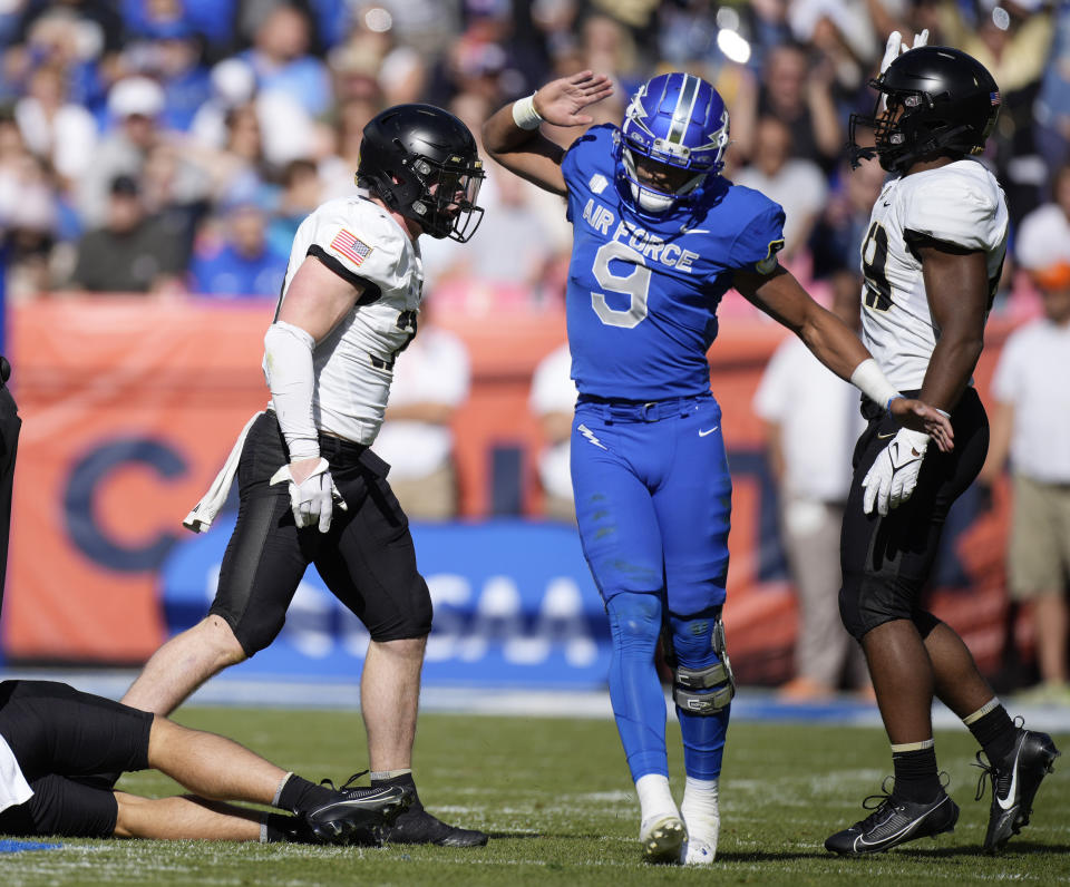Air Force quarterback Zac Larrier, right, reacts after Army linebacker Jimmy Ciarlo recovered an Air Force fumble in the first half of an NCAA college football game Saturday, Nov. 4, 2023, in Denver. (AP Photo/David Zalubowski)