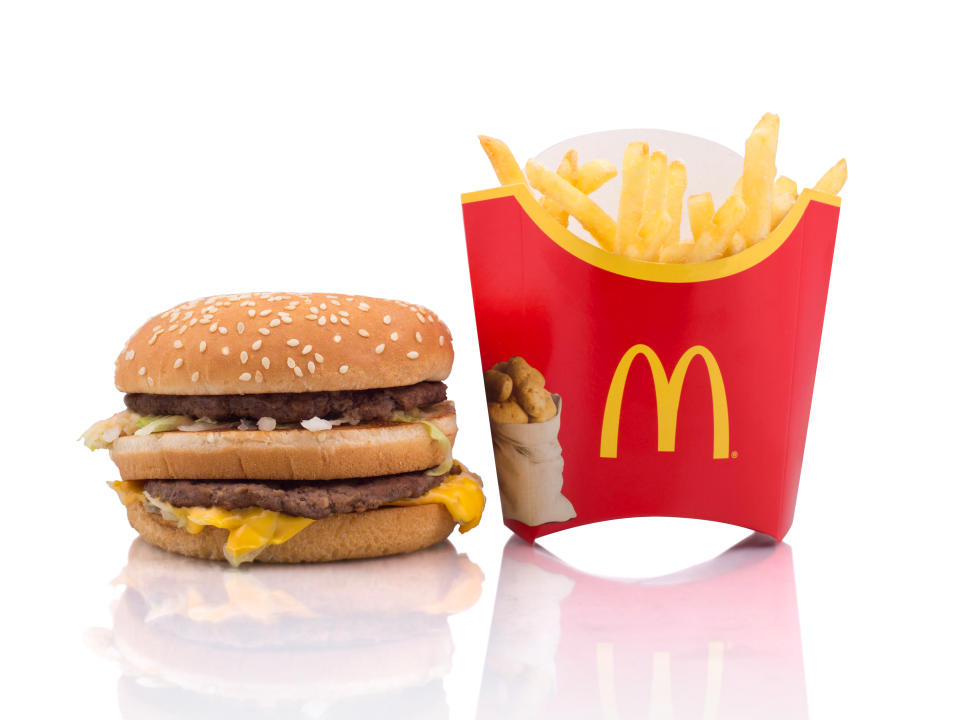 Photo of a  Big Mac hamburger and McDonalds fries on white background. 
