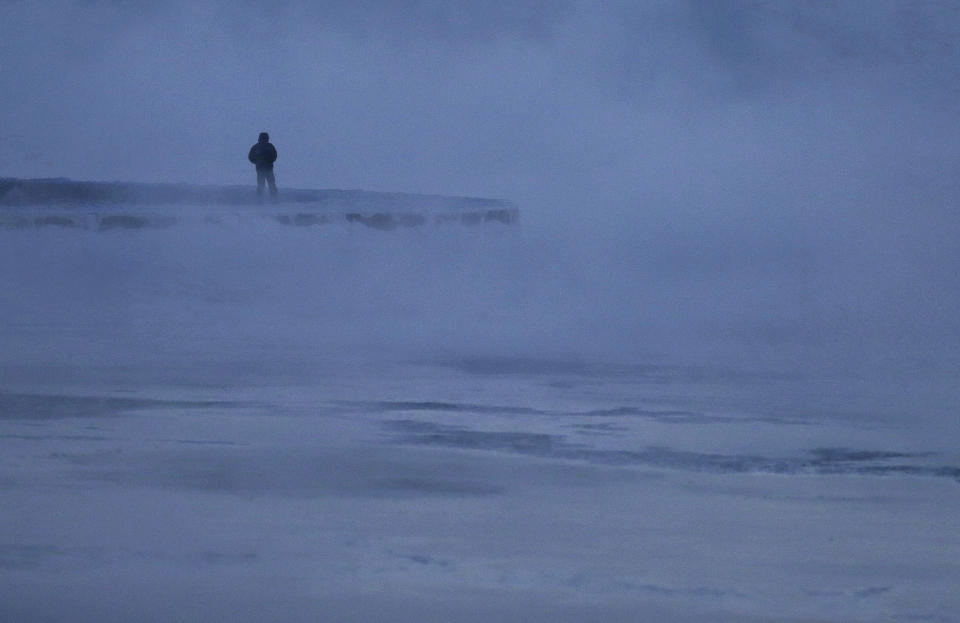 A man walks along the shore of Lake Michigan, Wednesday, Jan. 30, 2019, in Chicago.&nbsp;