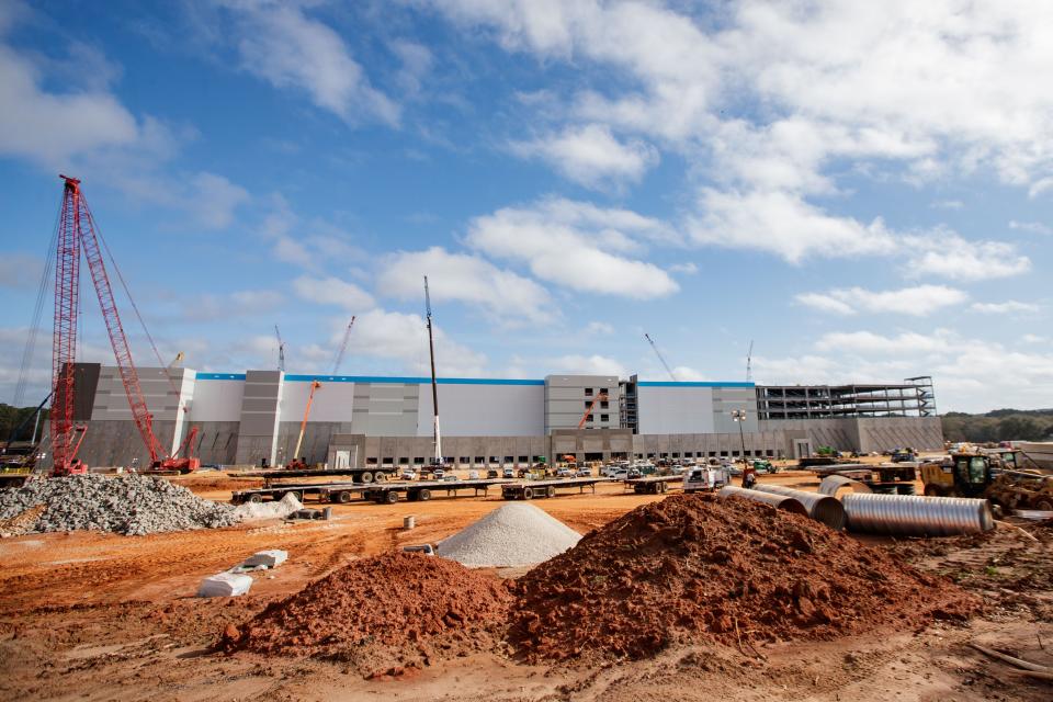 Dozens of workers construct the Amazon facility Thursday, Feb. 17, 2022.