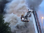 Firefighters battle a fire at a department store in Chingford, London, Britain August 23, 2017 in this still image obtained from social media. Jonathan Boyce via REUTERS