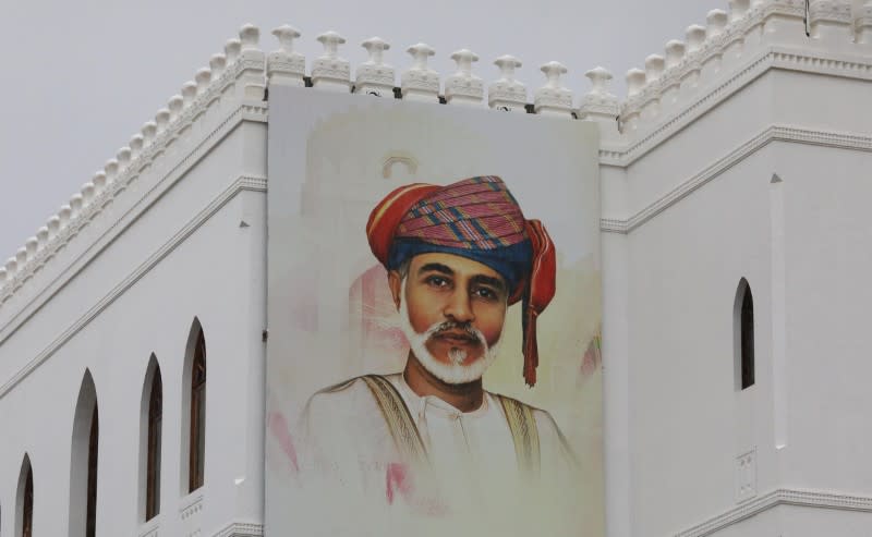 A painting of Oman's Sultan Qaboos bin Said is seen on a building in Muscat
