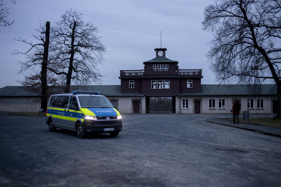 A police patrol officers in a car passes the main gate of the former Nazi concentration camp Buchenwald during a patrol in Weimar, Germany, Tuesday, Jan. 30, 2024. Attacks on the camp, now a memorial site, stepped up massively in recent months: an official Wagner says this is because of the "revisionist, antisemitic and racist slogans" promoted by the far-right Alternative for Germany, or AfD party. (AP Photo/Markus Schreiber)