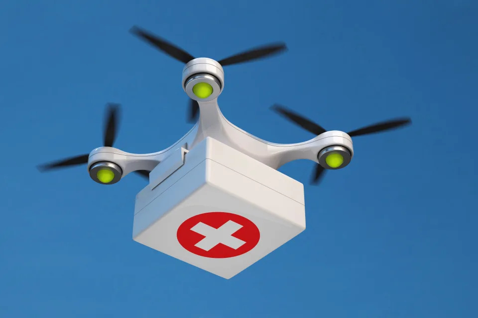 Drone quadcopter carrying first aid kit for fast emergency medical care.