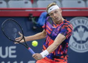 Denis Shapovalov, of Canada, returns the ball to Alex de Minaur, of Australia, during a first-round match at the National Bank Open tennis tournament in Montreal, Monday, Aug. 8, 2022. (Graham Hughes/The Canadian Press via AP)