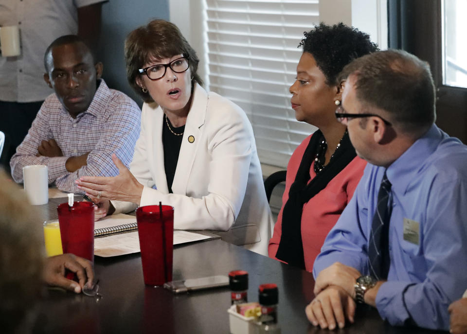 Florida Democratic gubernatorial candidate Gwen Graham, second from left, speaks with Jacksonville community leaders about gun violence Monday, Aug. 27, 2018, at a restaurant near the scene of a mass shooting on Sunday at The Jacksonville Landing in Jacksonville, Fla. A gunman opened fire at a video game tournament killing multiple people and then fatally shooting himself in a rampage that wounded several others. (AP Photo/John Raoux)