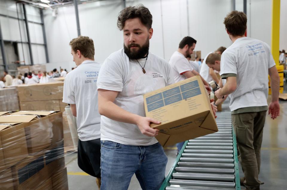 Sam McClelland moves food boxes during a service day, hosted by The Church of Jesus Christ of Latter-day Saints, to commemorate the 10th anniversary of its relationship with the United Nations World Food Programme and World Food Program USA, at Bishops’ Central Storehouse in Salt Lake City on Thursday, Feb. 8, 2024. | Kristin Murphy, Deseret News