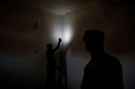 <p>Members of the Iraqi Army’s 9th Armoured Division inspect the cables of the surveillance system inside a compound used as a prison by Islamic State militants in the 17 Tamuz (July 17) district, in western Mosul, Iraq, June 6, 2017. (Alkis Konstantinidis/Reuters) </p>