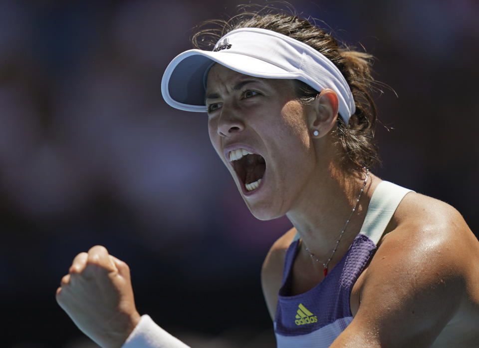 Spain's Garbine Muguruza reacts after winning the first set against Russia's Anastasia Pavlyuchenkova during their quarterfinal match at the Australian Open tennis championship in Melbourne, Australia, Wednesday, Jan. 29, 2020. (AP Photo/Lee Jin-man)