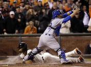 San Francisco Giants' Angel Pagan, bottom, scores under Los Angeles Dodgers catcher Tim Federowicz, top, after a double by Brandon Belt during the ninth inning of a baseball game on Tuesday, April 15, 2014, in San Francisco. (AP Photo/Marcio Jose Sanchez)