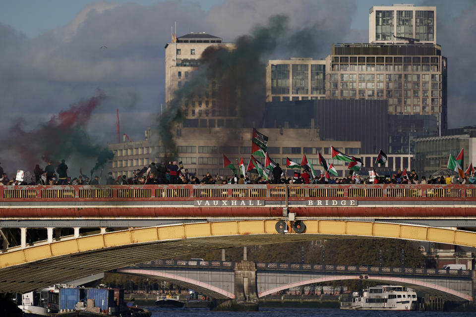 FILE - Protesters wave flags and hold flares during a pro-Palestinian protest in London, on Nov. 11, 2023. Antisemitism is spiking across Europe after Hamas' Oct. 7 massacre and Israel's bombardment of Gaza, worrying Jews from London to Geneva and Berlin. (AP Photo/Alberto Pezzali, File)