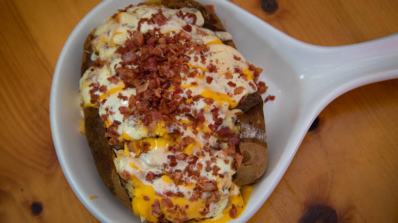 Baked potato with bacon bits and melted cheese