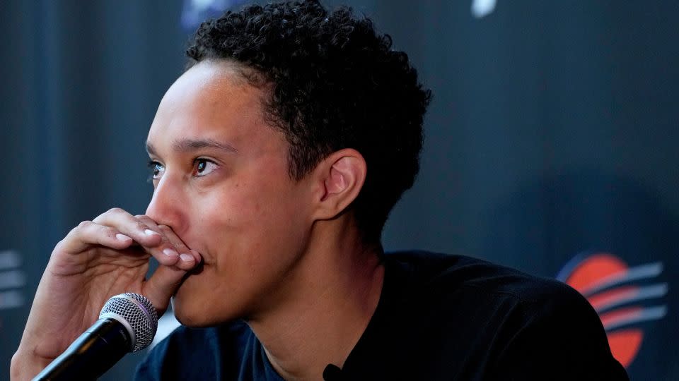 Griner fights back tears at the news conference. - Matt York/AP