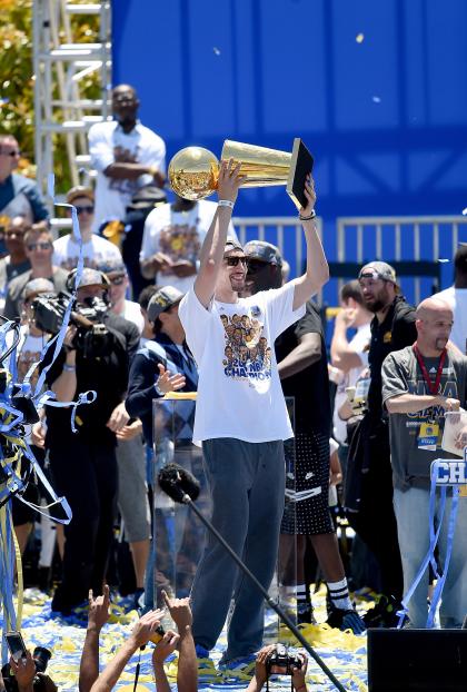 OAKLAND, CA - JUNE 19:  Klay Thompson #11 of the Golden State Warriors holding the Larry O&#39;Brien Trophy celebrates with his teammates at The Henry J. Kaiser Convention Center during thier Victory Parade and Rally on June 19, 2015 in Oakland, California.  (Photo by Thearon W. Henderson/Getty Images)