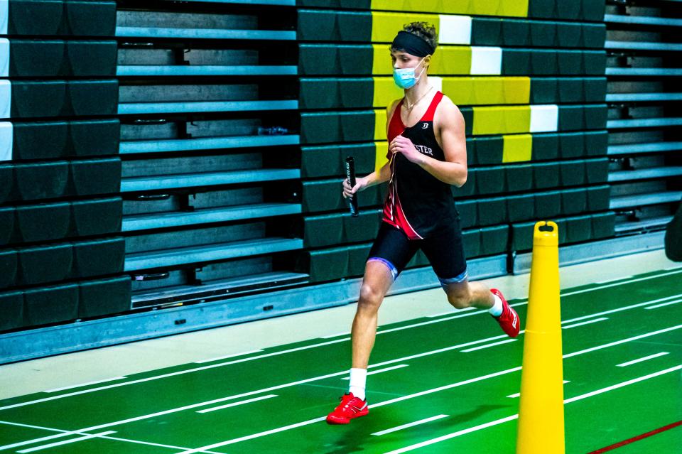 Old Rochester's Colby Gross crosses the finish line of the 4x400 relay race to take home first for Old Rochester.