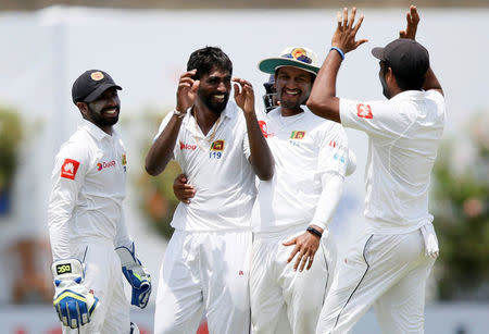 Cricket - Sri Lanka v India - First Test Match - Galle, Sri Lanka - July 27, 2017 - Sri Lanka's Nuwan Pradeep celebrates with his teammates after taking the wicket of India's Ravichandran Ashwin (not pictured). REUTERS/Dinuka Liyanawatte