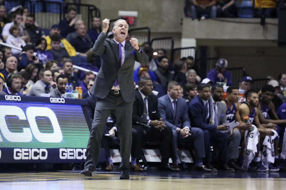 TCU coach Jamie Dixon reacts to a play during the first half of the team's NCAA college basketball game against West Virginia on Tuesday, Jan. 14, 2020, in Morgantown, W.Va. (AP Photo/Kathleen Batten)