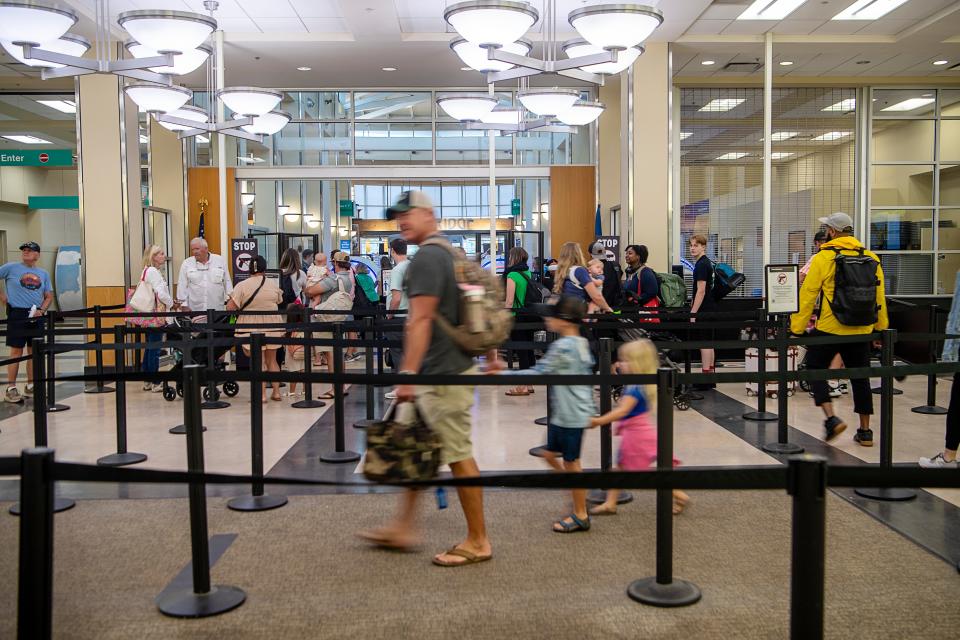 Travelers wait in line at Asheville Airports security checkpoint July 14, 2023.